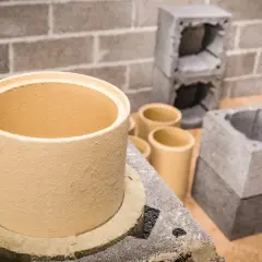 Ceramiczny wkład do komina z cegły, gotowy do montażu. Obok elementy konstrukcyjne komina.