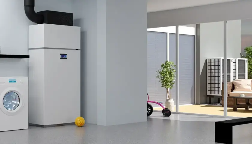 Nowoczesna pompa ciepła do domu 180m2 z grzejnikami, obok pralka i zabawki. Na zewnątrz widać taras z meblami.
